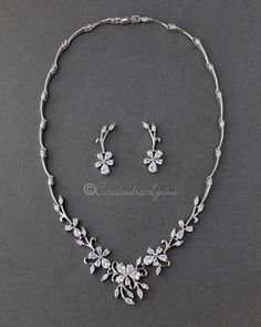 a necklace and earring set with flowers