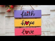 three wooden signs that say faith, hope and love