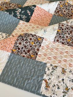 a close up of a patchwork quilt on a table