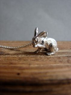 "Discover whimsical elegance with our Sterling Silver Bunny Necklace. This adorable piece of bunny jewelry is more than an accessory; it's a charming expression of grace and playfulness. Crafted with exquisite detail, this cute little bunny pendant, measuring about 1.5 cm, is transformed into a lovely necklace. The lobster clasp closure ensures secure wear, while the chain's total length of 16 inches offers versatility in styling. What makes this necklace truly special is the artistry behind it. Utilizing the ancient lost wax technique, each pendant is meticulously crafted, infusing it with a touch of tradition and craftsmanship that adds to its allure. This sterling silver rabbit necklace isn't just an accessory; it's an endearing piece perfect for everyday wear or as a thoughtful gift, e Jackrabbits Necklace, Animal Jewelry Pendants, Jackrabbits Necklace Blue, Bunny Pendant, Bunny Jewelry, Rabbit Necklace, Rabbit Jewelry, Bunny Necklace, Rabbit Pendant