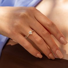 a woman's hand with a diamond ring on it