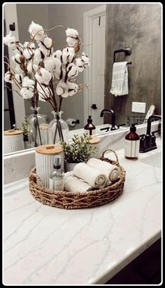 a bathroom counter with a basket on top of it filled with toiletries and flowers