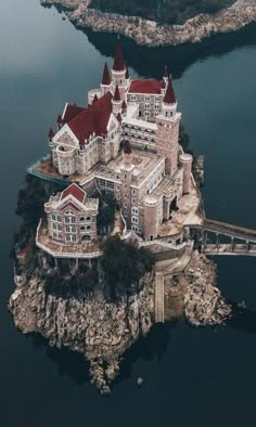 an aerial view of a castle on top of a small island in the middle of water