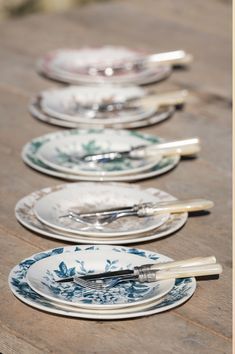 a row of plates sitting on top of a wooden table