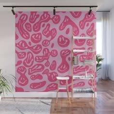 a pink wall mural in an apartment with wooden flooring and white walls, along with a ladder