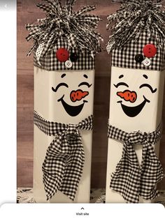 two white boxes decorated with black and white checkered fabric, one has a clown face on it