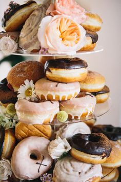 Doughnut Tower wedding cake from Crosstown with floral decor. Donut Stack, Doughnut Wedding, Doughnut Tower, Moon Headpiece, Doughnut Wedding Cake, Industrial Style Wedding, Donut Wedding Cake, Drip Wedding Cake, Donut Wedding