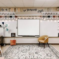 a room with a rug, chair and whiteboard