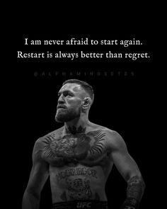 a man with tattoos on his chest standing in front of a quote from the wrestler