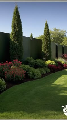 a lush green yard with flowers and trees