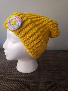 Warm. Sunny. Yellow. 100% acrylic. Who doesn't want to take some sun along with them?  A whimsical button to add just a pop of bling. Trendy One-size Acrylic Hat, Trendy One Size Acrylic Hat, Trendy Acrylic Hat One Size, One Size Brimmed Acrylic Beanie, Trendy Knitted Acrylic Hat, Trendy Crochet Acrylic Cap, Trendy Acrylic Crochet Hat, Trendy Acrylic Crochet Cap, Adjustable Spring Beanie Cap