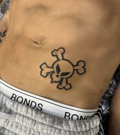 a man with a skull and crossbone tattoo on his stomach