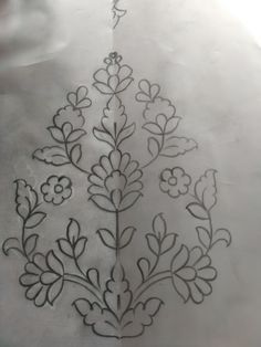 an embroidered piece of cloth with flowers and leaves drawn on the side, in black ink