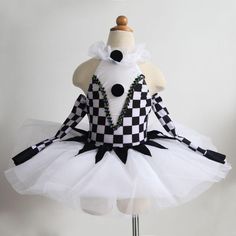 a mannequin dressed in a white and black checkerboard tutu skirt