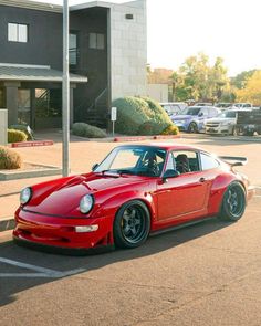 a red sports car parked in a parking lot