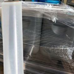 several rolls of clear plastic sitting on top of a table