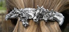 a close up of a pony's head with silver hair clips