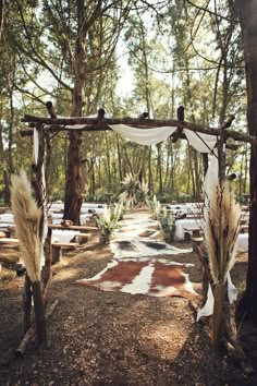 an outdoor wedding setup with white drapes and pamodia in the foreground