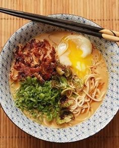 a bowl of ramen with chopsticks and an egg