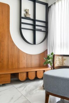 a wooden bench sitting next to a window in a living room under a round mirror