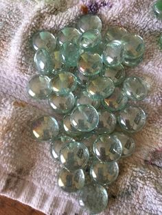 a pile of glass buttons sitting on top of a towel