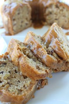 slices of apple pecan cake with caramel glaze on a white platter