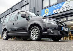 a black van parked in front of a building