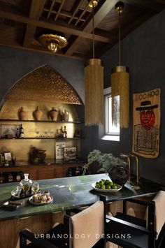 the kitchen is decorated in black and gold with an arched window above the countertop