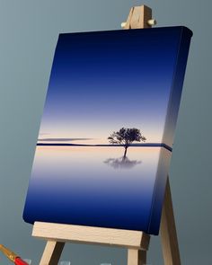 an easel with a painting on it and a small tree in the middle is shown