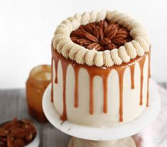 a cake with caramel drizzle and pecans on top