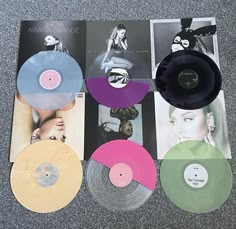 several different colored records are on the floor