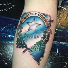 a tattoo on the leg of a man with a star and wreath around it that says battle born nevada