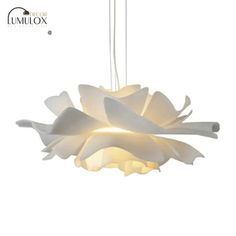 a white light hanging from the ceiling with flowers on it's petals and lightshade