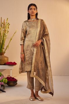 Grey-gold kurta in tissue brocade base with hand embroidery on neck. Comes with champagne grey cigarette pant. - Aza Fashions Gold Unstitched Suit With Dupatta For Formal Occasions, Gold Unstitched Suit With Dupatta For Formal Events, Gold Sharara With Sheer Dupatta For Formal Occasions, Formal Gold Sharara With Sheer Dupatta, Gold Raw Silk Unstitched Suit For Reception, Elegant Gold Kurta With Dupatta, Elegant Gold Unstitched Suit For Festive Occasions, Elegant Unstitched Gold Salwar Kameez, Elegant Gold Salwar Kameez With Zari Work