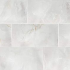 white marble tiles with gold veining on the edges and bottom, all in different sizes