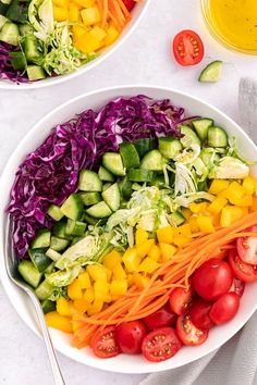 two white bowls filled with different types of vegetables and salad dressing next to each other