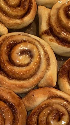 cinnamon buns with icing sitting on top of each other