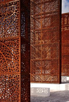 an intricately designed wooden structure in the middle of a courtyard