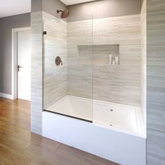 an empty bathroom with a glass shower door