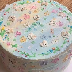 there is a cake decorated with cats and flowers