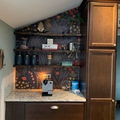 a coffee maker sits on top of a wooden cabinet