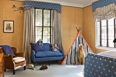 a child's room with a teepee tent, chair and dog in it