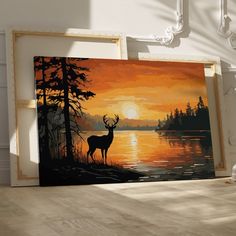 a painting of a deer standing in front of a lake at sunset