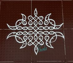 an intricate design is drawn on the floor with white paint and green lettering that reads parels