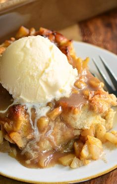 a white plate topped with an ice cream and apple cobbler next to a fork