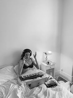 a woman laying in bed listening to music on her headphones