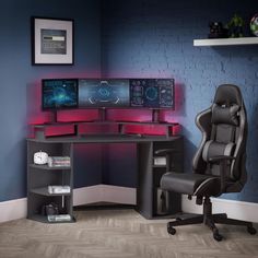 a computer desk with three monitors and a chair in front of it on top of a hard wood floor