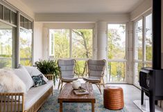 a living room filled with furniture and lots of windows