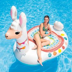 a woman sitting on an inflatable pool float with a dog and rabbit design