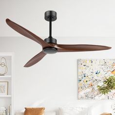 a ceiling fan in a living room with white walls